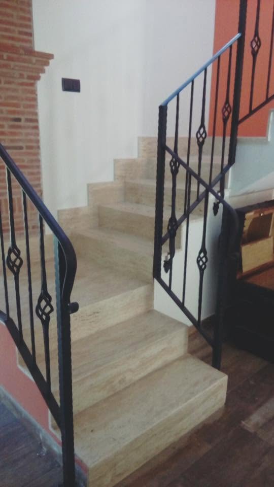 Escalera interior revestida en mármol travertino